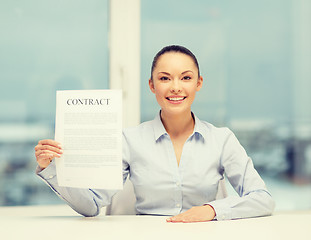 Image showing happy businesswoman holding contract in office