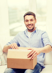 Image showing man with cardboard boxes at home