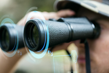 Image showing close up of soldier or hunter with binocular