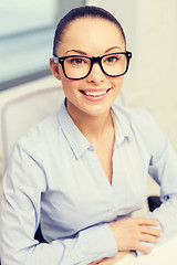 Image showing smiling businesswoman in eyeglasses in office