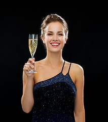 Image showing smiling woman holding glass of sparkling wine