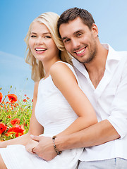 Image showing happy couple having fun over poppy flowers field