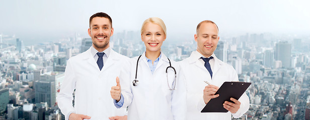 Image showing group of doctors showing thumbs up over white