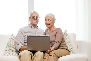 Image showing happy senior couple with laptop at home