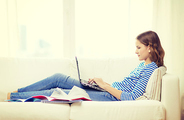 Image showing busy teenage girl with laptop computer at home