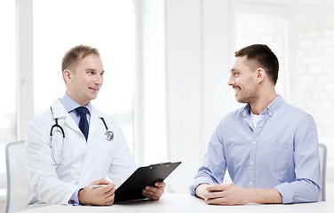 Image showing doctor with clipboard and patient in hospital