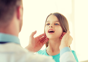 Image showing male doctor checks little girl lymph nodes