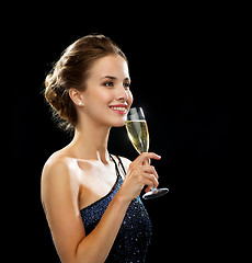 Image showing smiling woman holding glass of sparkling wine