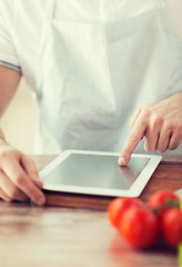 Image showing closeup of man pointing finger to tablet pc