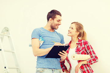 Image showing smiling couple with clipboard and wallpaper roll