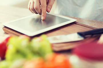 Image showing closeup of man pointing finger to tablet pc