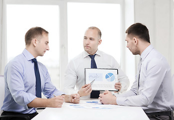 Image showing serious businessmen with papers in office