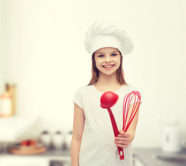 Image showing smiling girl in cook hat with ladle and whisk