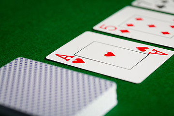 Image showing close up of playing cards on green table surface