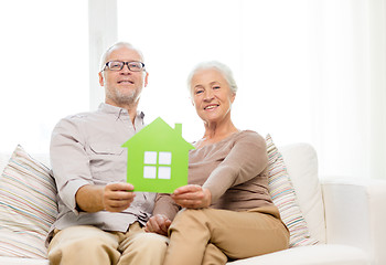 Image showing happy senior couple hugging on sofa at home