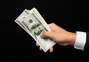 Image showing close up of male hands holding dollar cash money