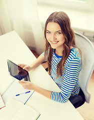 Image showing smiling student girl with tablet pc and books