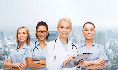 Image showing smiling female doctor and nurses with stethoscope