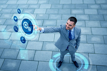 Image showing young smiling businessman outdoors from top