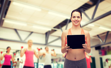 Image showing sporty woman with tablet pc blank screen