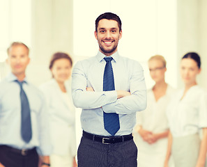 Image showing handsome businessman with crossed arms