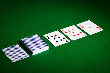Image showing playing cards on green table surface