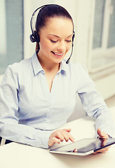 Image showing friendly female helpline operator with tablet pc