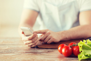 Image showing closeup of man pointing finger to smartphone