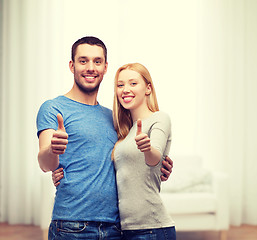 Image showing smiling couple showing thumbs up