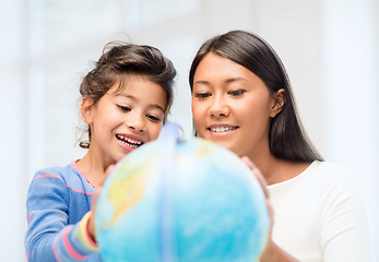 Image showing mother and daughter with globe