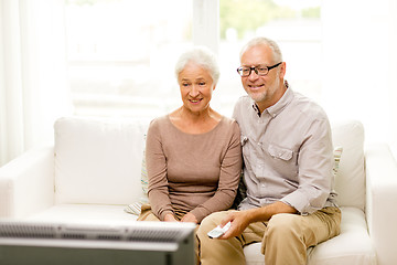 Image showing happy senior couple watching tv at home