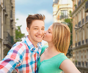 Image showing happy couple taking selfie over city background