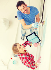 Image showing smiling couple painting wall at home