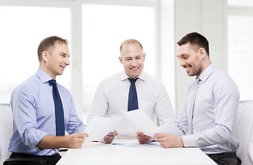 Image showing smiling businessmen with papers in office