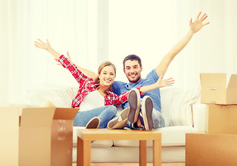 Image showing smiling couple relaxing on sofa in new home