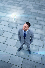 Image showing young smiling businessman outdoors from top