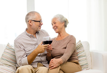 Image showing happy senior couple with glasses of red wine