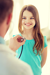 Image showing male doctor with stethoscope listening to child