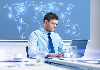 Image showing businessman with laptop working in office