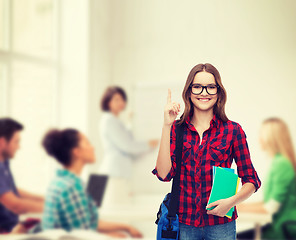 Image showing smiling female student with bag and notebooks