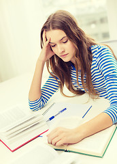 Image showing stressed student girl with books