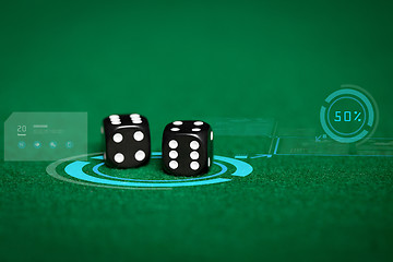 Image showing close up of black dice on green casino table