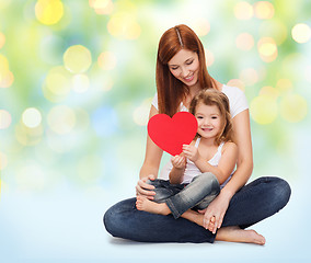 Image showing happy mother with little girl holding red heart