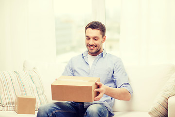 Image showing man with cardboard boxes at home