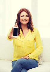 Image showing smiling woman with blank smartphone screen at home