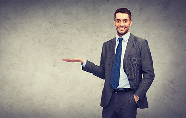 Image showing man showing something on the palm of his hand