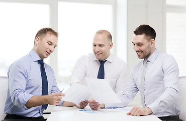 Image showing smiling businessmen with papers in office