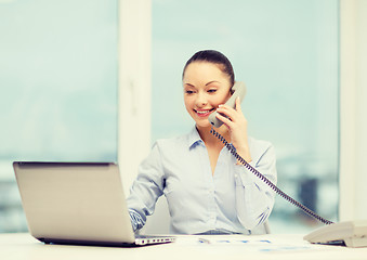 Image showing businesswoman with phone, laptop and files