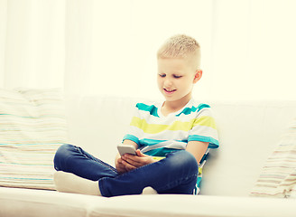 Image showing smiling little boy with smartphone at home