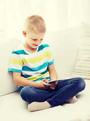 Image showing smiling little boy with smartphone at home